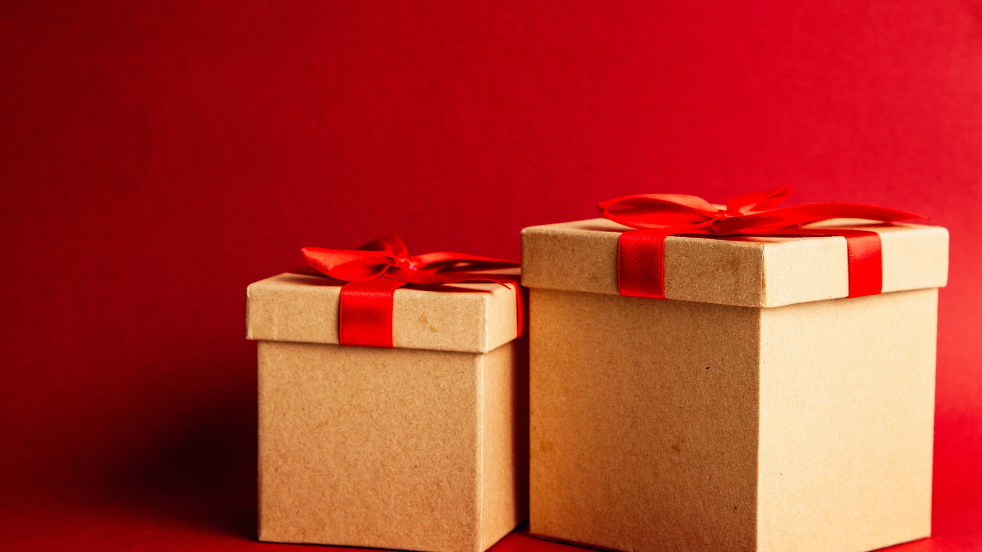 two-brown-and-red-gift-boxes-on-red-surface-1666070